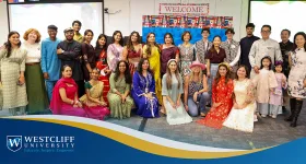 Group of Westcliff Students and Employeees posting in cultural attire at the International Food and Culture Festival