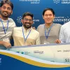Hackathon group holding a oversided check.