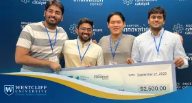 Hackathon group holding a oversided check.